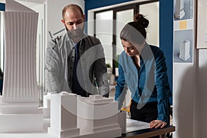 Architectural engineers doing teamwork reading construction plans