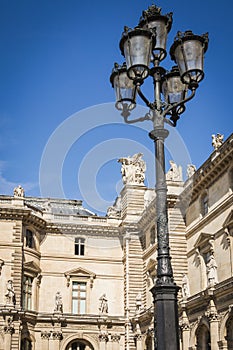 Architectural facade of the aisles and the lamps of the place of the pyramids of the Louvre museum in Paris