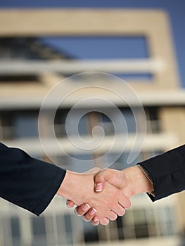 Architectural Handshaking in front of building