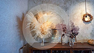 Architectural interior decorations with dried plants and lighting fixtures