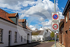 Architectural landscape of street with traffic signs against blue sky with clouds