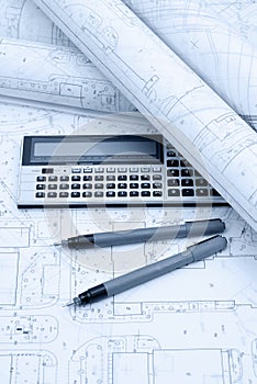 Architectural plans, calculator and drawing utensils