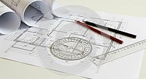 Architectural Plans and Drafting Tools Spread on Table