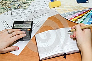 Architectural plans with palette of colors, money, calculator,