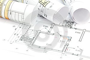 Architectural plans and technical drawings with rolls of blueprints