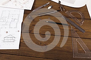 Architectural project, engineering tools on table.