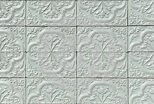 Architectural surface background.Gray painted ceramic relief tiles on a spanish house facade.