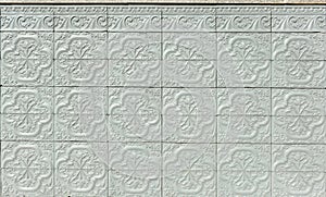 Architectural surface background.Gray painted ceramic relief tiles on a spanish house facade.