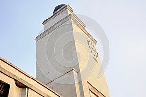 Architecture 30`s facade detail with clock tower. Italy.