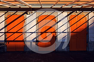 Architecture abstract background, three orange doors and shadows