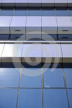 Architecture background fragment of a modern office building against blue sky