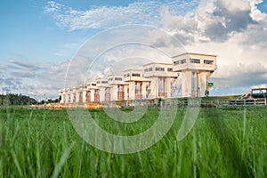 Architecture building beautiful Utho Wipat prasit floodgates over grass at sunset