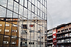 Architecture buildings background with new glass facade, old blocks and reflection