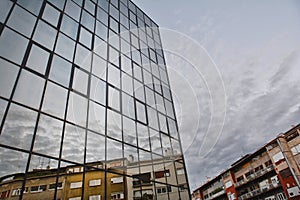 Architecture buildings background with new glass facade, old blocks and reflection