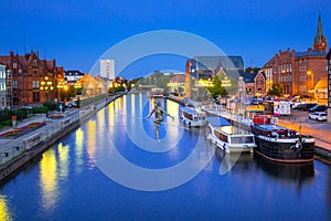 Architecture of Bydgoszcz city with reflection in Brda river at night