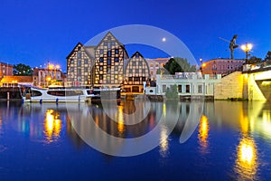 Architecture of Bydgoszcz city with reflection in Brda river at night