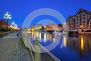 Architecture of Bydgoszcz city with reflection in Brda river at night