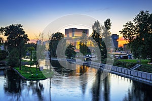 Architecture of Bydgoszcz city with reflection in Brda river at sunset