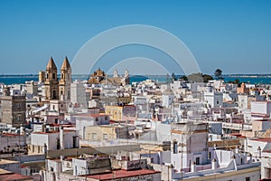 Architecture of CÃ¡diz from a viewpoint with church towers and the sea in the background, SPAIN photo