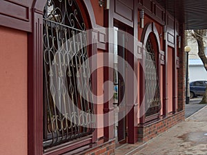 Street city architecture public access alley sidewalk stained glass windows door tree red