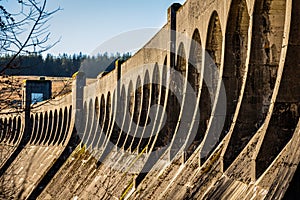 The architecture of Clatteringshaws Dam, with arches along the top of the dam