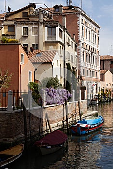 Architecture of colorful houses and boats on a canal in Venice