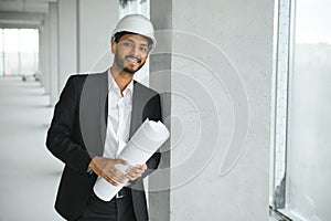 architecture, construction business and building concept - happy smiling indian male architect in helmet.