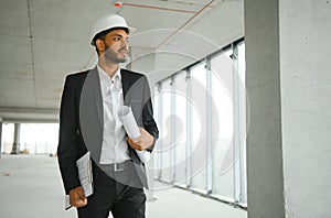 architecture, construction business and building concept - happy smiling indian male architect in helmet.