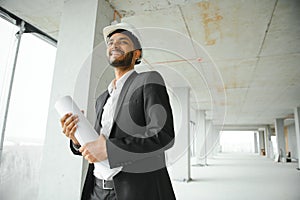 architecture, construction business and building concept - happy smiling indian male architect in helmet.
