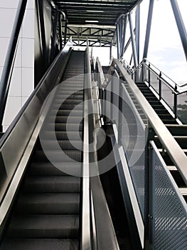 Architecture construction of elevator, escalator stairs and sky walk way, walk bridge between sky train station and department sto