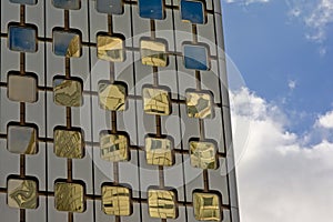 Architecture detail, windows with rounded corners of an office building and blue sky with clouds