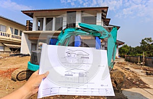 Architecture drawings in hand on big house building