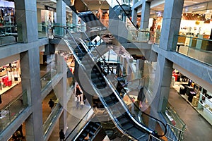 Architecture, Mirror escalators move in a modern shopping mall, galleries with shops, sales. City of Dnipro, Dnepropetrovsk,