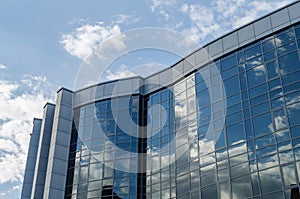 The architecture of the modern city. Business center. Reflection of the sky in windows of office building.