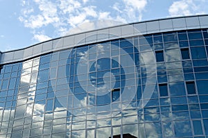 The architecture of the modern city. Business center. Reflection of the sky in windows of office building.