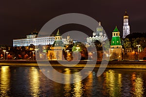 Architecture of Moscow Kremlin at night with reflection of night illumination on surface of Moskva river