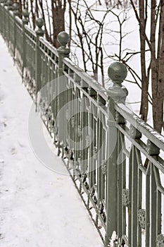 Architecture and old iron fence of park in vintage style