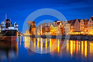 Architecture of the old town in Gdansk over Motlawa river at night
