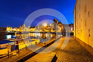 Architecture of the old town in Gdansk over Motlawa river at night