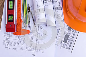 Architecture plan and rolls of blueprints with tool kit