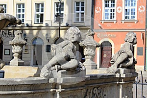 Poland, Poznan, Stary Rynek - closeup photo with status of little angel, a fountain, archutecure