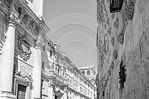 Architecture in Salamanca, Spain; view of the Casa de las Conchas and a Baroque church in the background