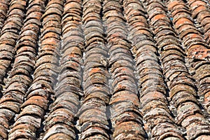 Architecture textures, detailed view of a old and damage italian orange roof tile texture, typical and traditional shale stone