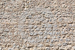 Architecture textures, detailed view of a traditional and rustic paired masonry, granite wall, used on a fortress castle wall