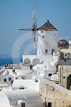 Architecture with windmills on a hillside in Oia village on Santorini island, Greece Mediterranean sea