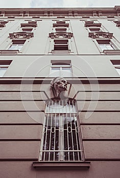 Architecture and windows of ancient renaissance style classical building. Beige color ancient walls and brown casement window