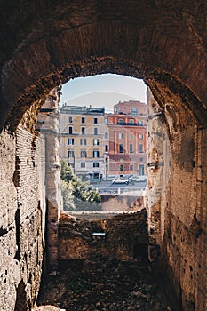 Archway in Colosseum with Rome city streets visible