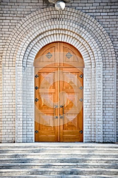 Archway entrance with golden oak doors