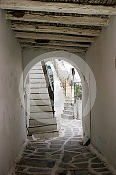 Archway with exposed beams and cobblestone