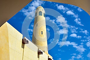 Archway Framed Minaret with white clouds